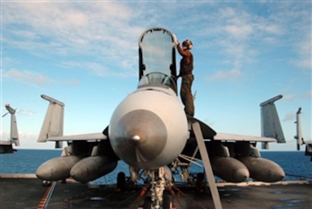 U.S. Navy Airman Apprentice Herbert Counts, an aircraft captain, performs routine maintenance on an F/A-18E Super Hornet aircraft aboard the aircraft carrier USS George Washington (CVN 73) underway in the Pacific Ocean on Nov. 6, 2009.  The ship, the Navy's only permanently forward-deployed aircraft carrier, is supporting security and stability in the western Pacific Ocean. The aircraft is assigned to Strike Fighter Squadron 27.  