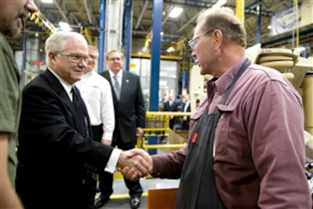 Defense Secretary Robert M. Gates meets with a worker during a tour of the MRAP-All Terrain Vehicle production facility in Oshkosh, Wis., Nov. 12, 2009. The vehicle design combines the crew protection warfighters have come to expect in MRAP vehicles with the extreme mobility and durability needed to negotiate mountainous off-road terrain.