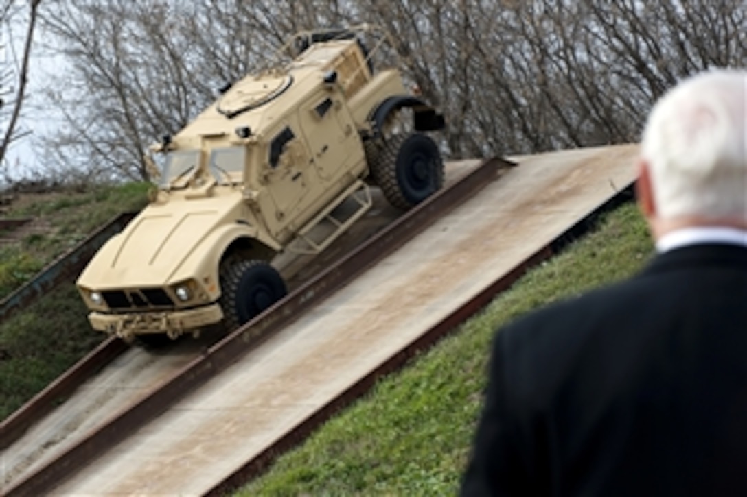 Defense Secretary Robert M. Gates watches a demonstration of the MRAP-All Terrain Vehicle at the test facility in Oshkosh, Wis., Nov. 12, 2009. The design of the vehicle, known as an M-ATV, combines the protection warfighters have come to expect in MRAP vehicles with the extreme mobility and durability needed to negotiate mountainous off-road terrain.  