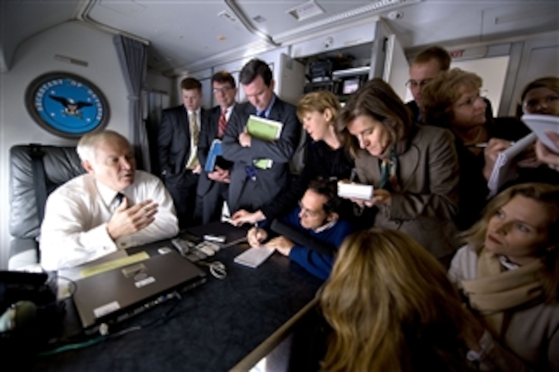 Secretary of Defense Robert M. Gates speaks with members of the press onboard an aircraft destined for Oshkosk, W.I., to tour the MRAP-All Terrain Vehicle (M-ATV) production facility on Nov. 12, 2009.  The M-ATV design combines the crew protection war fighters have come to expect in MRAP vehicles with the extreme mobility and durability needed to negotiate mountainous off-road terrain.  