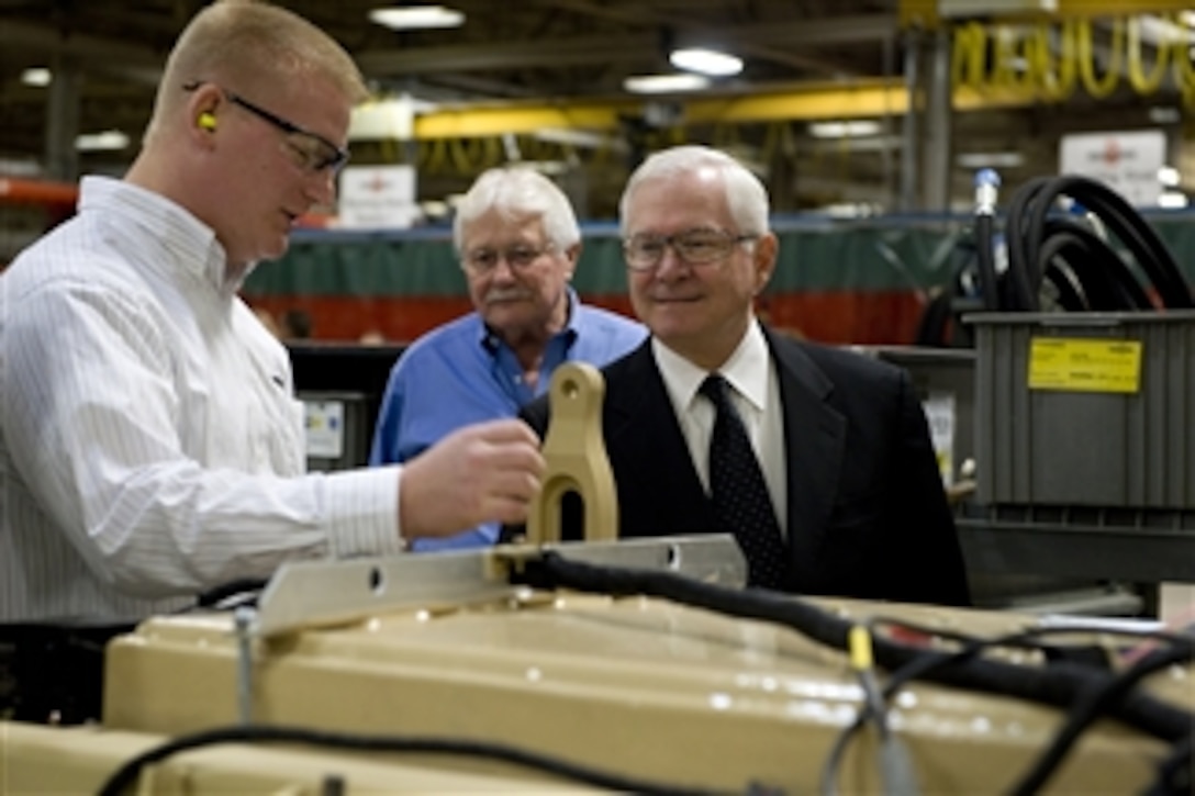 Jake Jones, Operations Manager, gives Secretary of Defense Robert M. Gates a tour of the MRAP-All Terrain Vehicle (M-ATV) production facility in Oshkosk, W.I., on Nov. 12, 2009.  The M-ATV design combines the crew protection war fighters have come to expect in MRAP vehicles with the extreme mobility and durability needed to negotiate mountainous off-road terrain.  