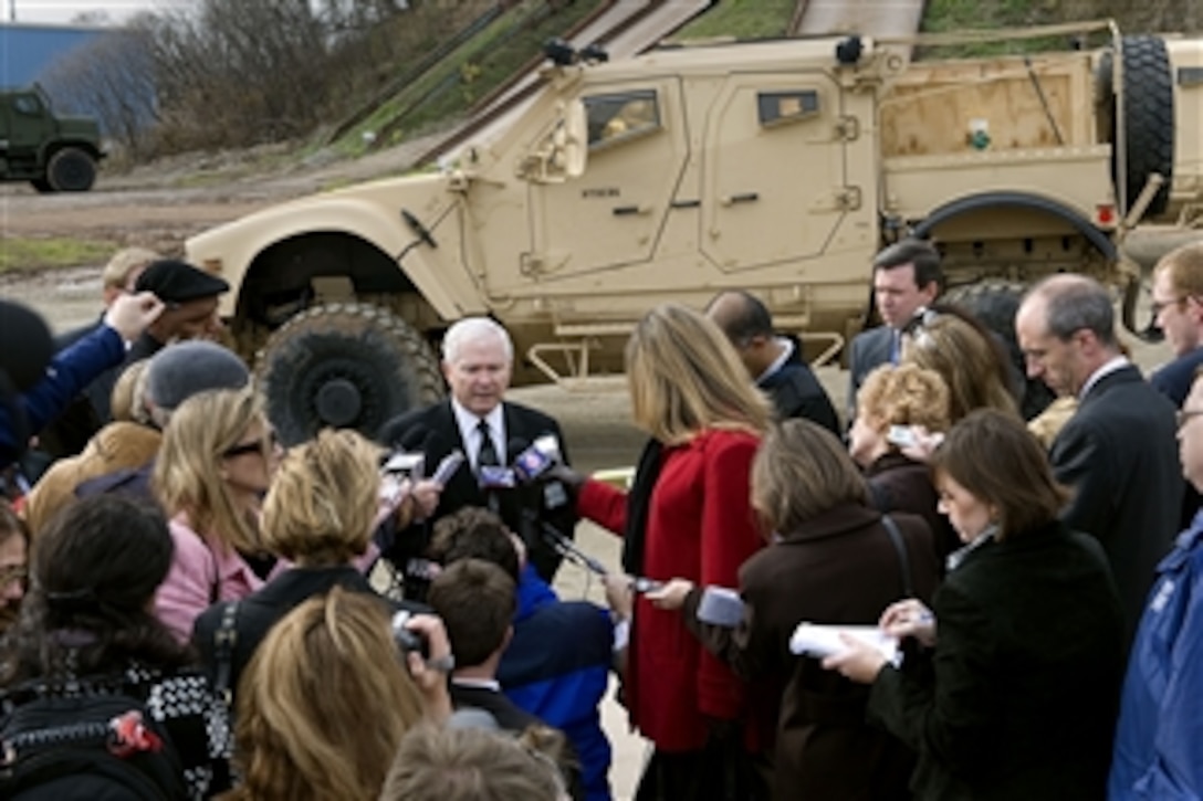 Secretary of Defense Robert M. Gates speaks with the press following a tour of the MRAP-All Terrain Vehicle (M-ATV) production facility and the test facility in Oshkosk, W.I., on Nov. 12, 2009.  The M-ATV design combines the crew protection war fighters have come to expect in MRAP vehicles with the extreme mobility and durability needed to negotiate mountainous off-road terrain.  