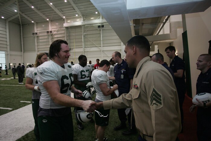 FLORHAM PARK, N.J. -- A Marine from 2nd Battalion, 25th Marine Regiment, meets with Alan Franca, left guard, New York Jets, during a tour of the team's practice facility Nov. 13. The team invited service members to their practice and Sunday the Jets will honor military veterans during their military appreciation day. (Official Marine Corps photo by Sgt. Randall A. Clinton)