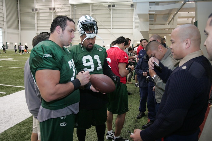 FLORHAM PARK, N.J. -- Marines from Recruiting Station New Jersey meet with Mike DeVito, #70 defensive end, New York Jets, and Sione Pouha, #91 defensive end, New York Jets, during a tour of the team's practice facility Nov. 13. The team invited service members to their practice and Sunday the Jets will honor military veterans during their military appreciation day. (Official Marine Corps photo by Sgt. Randall A. Clinton)