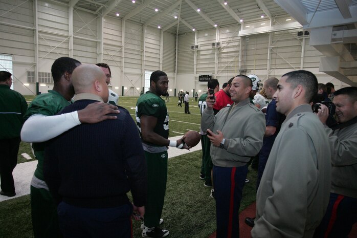 FLORHAM PARK, N.J. -- Marines from Recruiting Station New Jersey meet with Bart Scott, linebacker, New York Jets, during a tour of the team's practice facility Nov. 13. The team invited service members to their practice and Sunday the Jets will honor military veterans during their military appreciation day. (Official Marine Corps photo by Sgt. Randall A. Clinton)