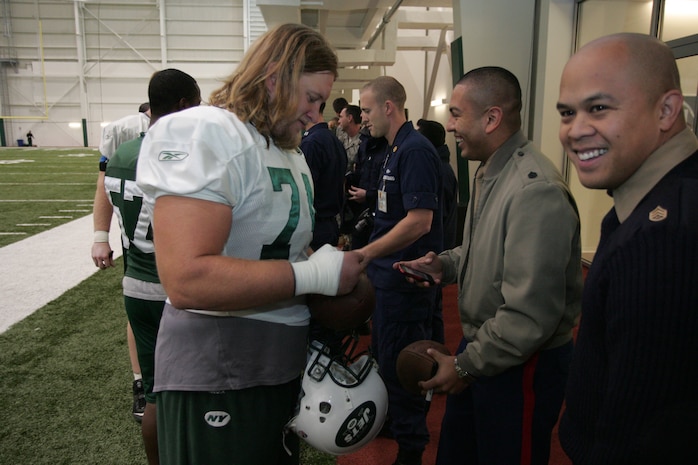 FLORHAM PARK, N.J. -- Marines from Recruiting Station New Jersey meet with Nick Mangold, center, New York Jets, during a tour of the team's practice facility Nov. 13. The team invited service members to their practice and Sunday the Jets will honor military veterans during their military appreciation day. (Official Marine Corps photo by Sgt. Randall A. Clinton)