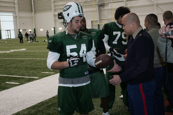 FLORHAM PARK, N.J. -- Marines from Recruiting Station New Jersey meet with Kenwin Cummings, linebacker, New York Jets, during a tour of the team's practice facility Nov. 13. The team invited service members to their practice and Sunday the Jets will honor military veterans during their military appreciation day. (Official Marine Corps photo by Sgt. Randall A. Clinton)