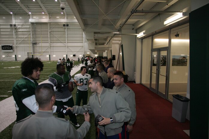 FLORHAM PARK, N.J. -- Marines from Recruiting Station New Jersey meet with the New York Jets during a tour of the team's practice facility Nov. 13. The team invited service members to their practice and Sunday the Jets will honor military veterans during their military appreciation day. (Official Marine Corps photo by Sgt. Randall A. Clinton)