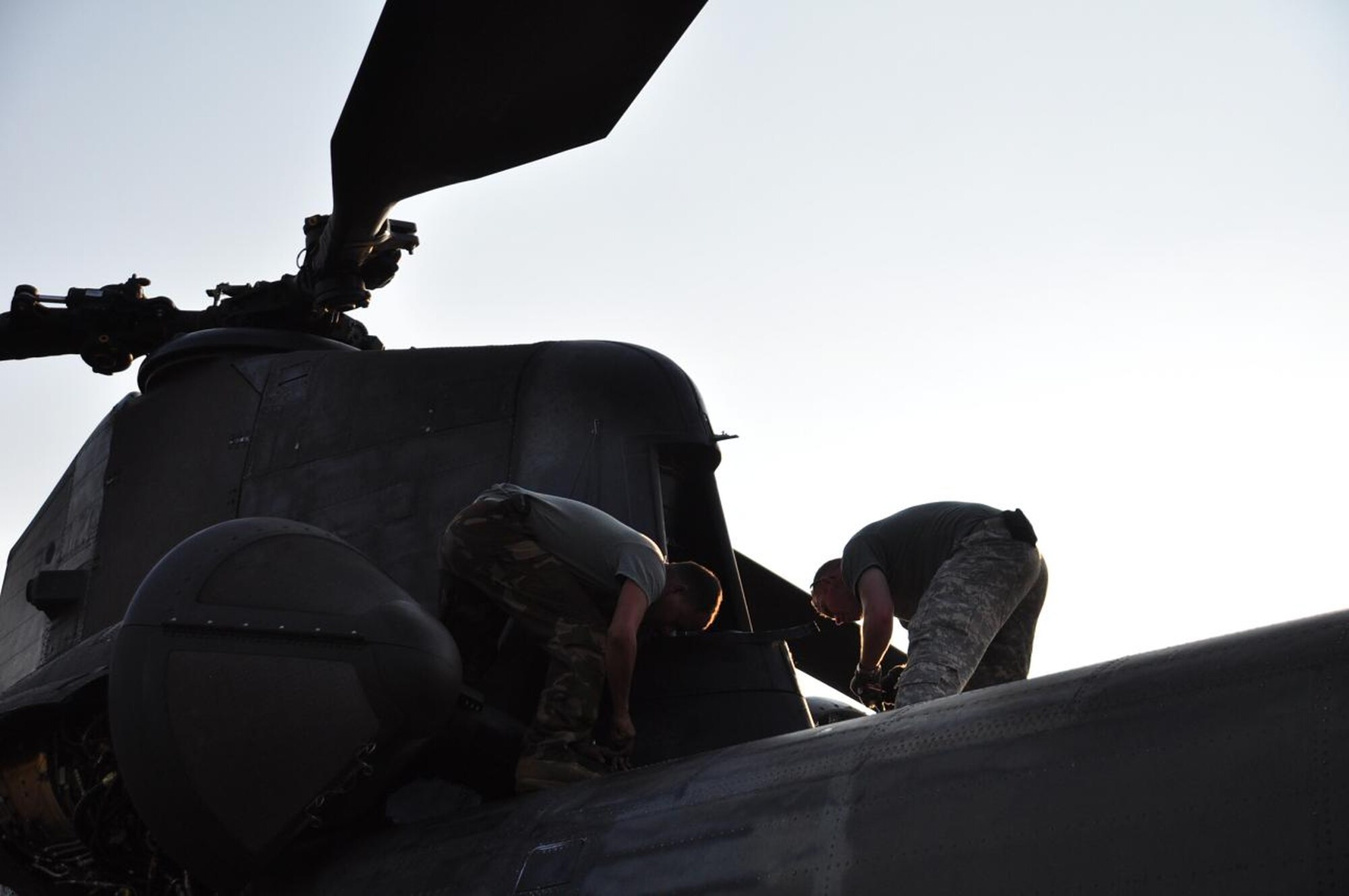 ILOPANGO, El Salvador – Army staff sergeants Mario Sarria and Wade Cothron, both Soldiers assigned to Joint Task Force-Bravo, perform pre-flight and post-flight checks on a CH-47 Chinook Nov. 14. JTF-Bravo has been providing vital relief supplies in order to help stabilize the region after a devastating flood Nov. 8. In three days the team of four helicopters and crew has distributed more than 172,700 pounds of supplies in a total of 42 flight hours (U.S. Air Force photo/Staff Sgt. Chad Thompson).