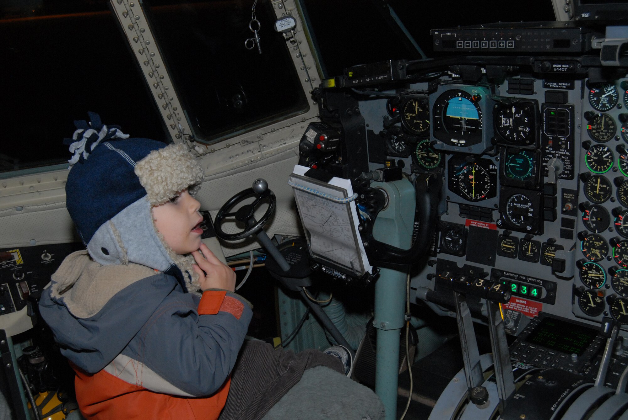 A child sits in the cockpit of a C-130 Nov. 6 as part of the 2nd Airlift Squadron Family Day. Children and spouses of the 2nd AS members were invited to explore a static display of a C-130. (U.S. Air Force Photo by 2nd Lt. Cammie Quinn) 