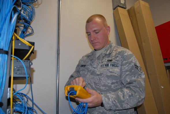 Airman 1st Class Var Gehron, 43rd Communications Squadron, pulls an Internet protocol addresses from a switch as part of his job in the network control center. 