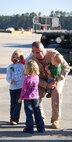 Capt. Rod Jones gets an eager greeting from his children upon his return from Al Udeid, Qatar. Captain Jones, a pilot with the 911th Air Refueling Squadron, deployed to the desert for a 90-day rotation. Nearly 200 members of the 916th Air Refueling Wing returned from deployments to the Middle East and Pacific in early November. (U.S. Air Force photo by Ms. Donna Lea, 916ARW/PA)