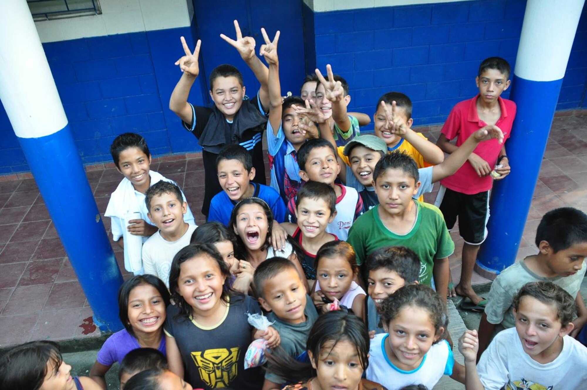 SAN DIEGO, El Salvador -- Curious Salvadoran children follow a medical assesment team around Nov. 13. Guillermo Saenz, Joint Task Force-Bravo Medical Element liaison officer, lead the medical assessment team to several villages affected by the Nov. 8 mudslides in order to determine whether it would be affective to perform a medical readiness and training exercise, or MEDRETE. JTF-Bravo has been in El Salvador since Nov. 11 providing airlift operations and tranporting more than 82,000 pounds of supplies (U.S. Air Force photo/Staff Sgt. Chad Thompson).