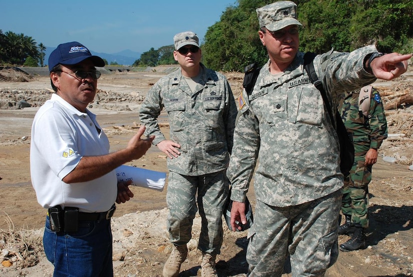 ILOPANGO, El Salvador—Air Force Lt. Col. Anthony Higdon and Army Lt. Col. Jose Gierbolini, engineers from U.S. Southern Command, discuss damage assessment with a representative of El Salvador’s Ministry of Public Works Nov. 13. The combined U.S., Salvadoran damage assessment team is working together to gather data from areas with damaged by flooding and landslides. Joint Task Force-Bravo, based out of Soto Cano Air Base, Honduras, has been helping in El Salvador since Nov. 11, providing humanitarian assistance and disaster relief to flood-damaged communities (U.S. Air Force photo/1st Lt. Jennifer Richard).