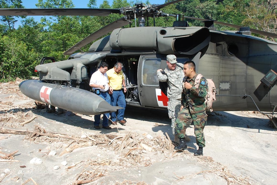 ILOPANGO, El Salvador—Members of a combined U.S., Salvadoran damage assessment team disembark a Joint Task Force-Bravo UH-60 helicopter Nov. 13 in an area affected by landslides caused by recent heavy rains. Engineers from U.S. Southern Command, together with Salvadoran military engineers, are assisting El Salvador’s Ministry of Health gathering data from areas with damaged infrastructure. Joint Task Force-Bravo, based out of Soto Cano Air Base, Honduras, has been helping in El Salvador since Nov. 11, providing humanitarian assistance and disaster relief to flood-damaged communities (U.S. Air Force photo/1st Lt. Jennifer Richard).