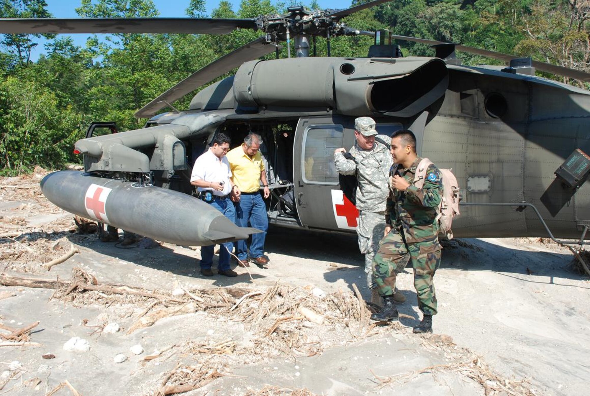 ILOPANGO, El Salvador—Members of a combined U.S., Salvadoran damage assessment team disembark a Joint Task Force-Bravo UH-60 helicopter Nov. 13 in an area affected by landslides caused by recent heavy rains. Engineers from U.S. Southern Command, together with Salvadoran military engineers, are assisting El Salvador’s Ministry of Health gathering data from areas with damaged infrastructure. Joint Task Force-Bravo, based out of Soto Cano Air Base, Honduras, has been helping in El Salvador since Nov. 11, providing humanitarian assistance and disaster relief to flood-damaged communities (U.S. Air Force photo/1st Lt. Jennifer Richard).