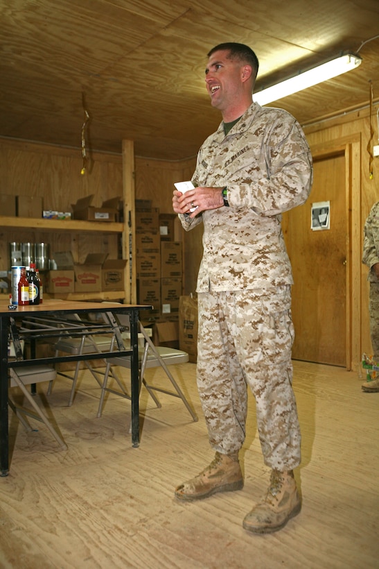 Maj. Christopher McGuire, an infantry officer with Border Transition Team 4210, speaks to Marines and sailors attending the 234th Marine Corps birthday celebration aboard Combat Outpost Nukhayb, Iraq, Nov. 14, 2009. After the ceremony, they enjoyed a birthday meal, some birthday cake and two beers apiece.