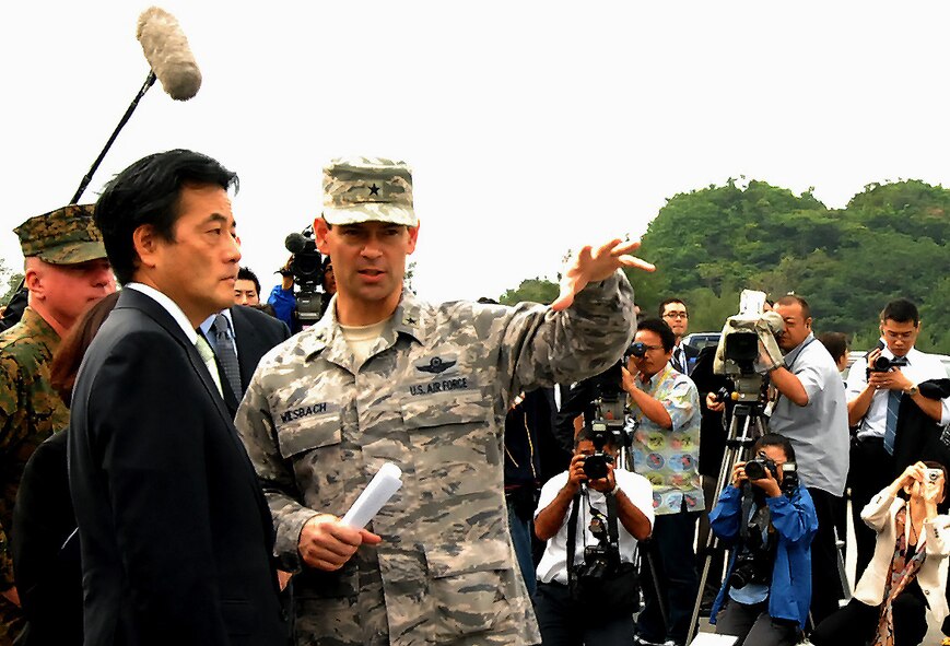 Brig. Gen. Ken Wilsbach, 18th Wing commander, talks with Japanese Foreign Minister Katsuya Okada during a site visit to Kadena Monday. According to Japanese press reports, the foreign minister toured Kadena to personally research the possibility of combining Marine Corps Air Station Futenma with the air base. The relocation of Futenma is a key measure of a major realignment plan signed by both countries three years ago. Nearly 50,000 U.S. troops are currently stationed in Japan.(Air Force/Staff Sgt. Jason Lake)