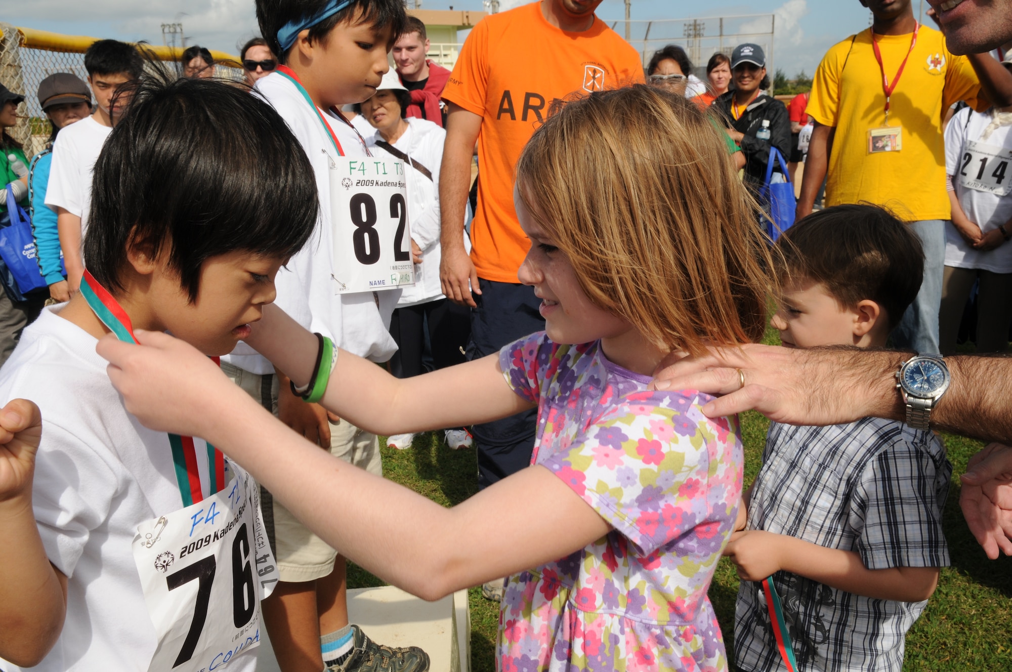 A young girl places a medal over an Okinawan athlete after competing in the 30 meter dash during the Kadena Special Olympics Nov. 14, 2009, Kadena Air Base, Japan. Kadena hosted the 10th Annual Special Olympic Games and Art Festival for special needs Okinawan and American adult and child athletes.
(U.S. Air Force photo/Airman 1st Class Amanda Grabiec) 