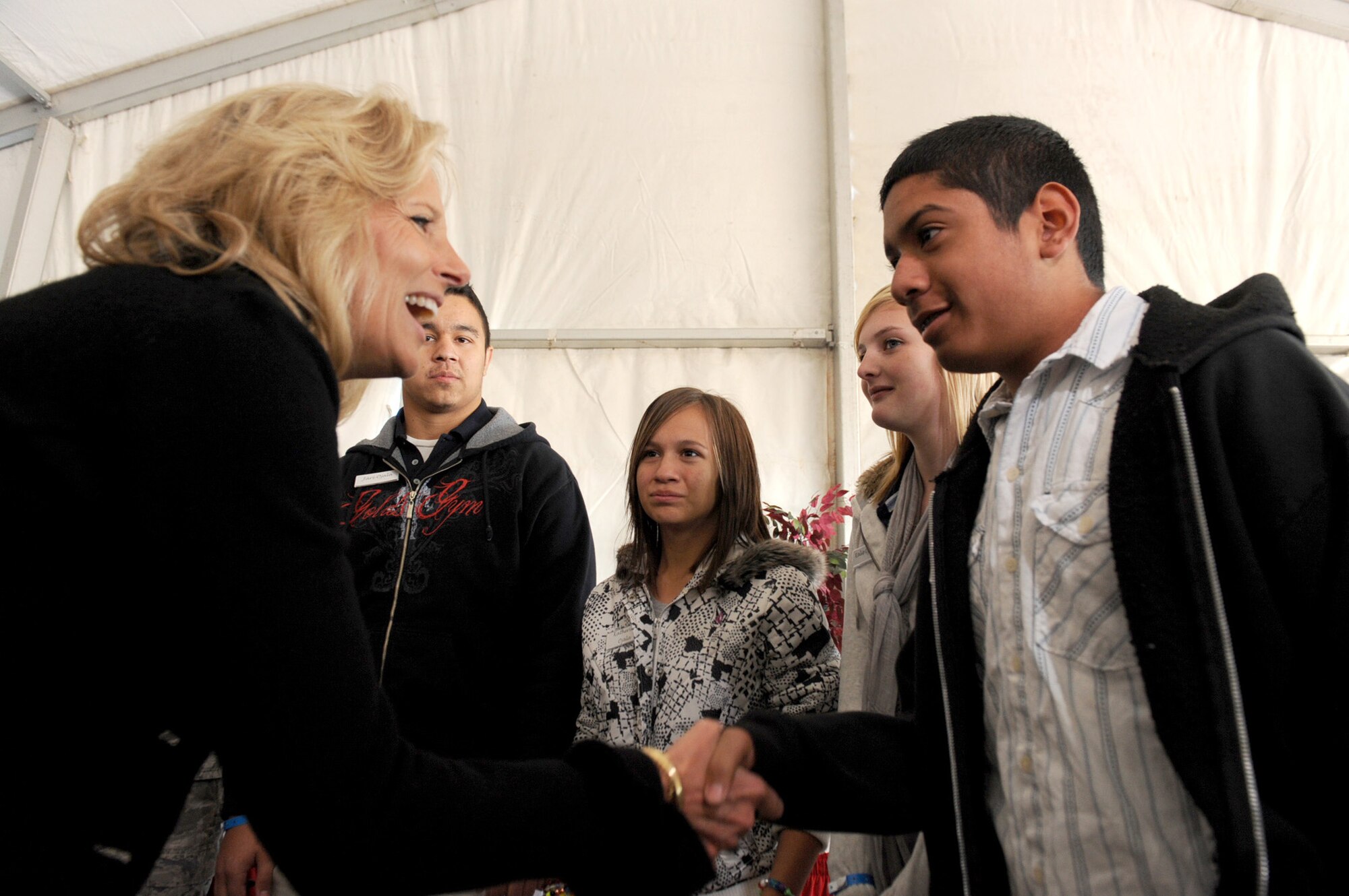 NELLIS AIR FORCE BASE, Nev.-- Dr. Jill Biden shakes hands with Anthony Brettler, son of Tech. Sgt. Steven Brettler, before having lunch with military families during her visit to Nellis Nov. 15. During her visit, Dr. Biden was provided with examples on how the support and services of Nellis' Airman and Family Readiness and Education programs have directly supported Airmen and their families.  
(U.S. Air Force photo by Airman 1st Class Jamie Nicley)