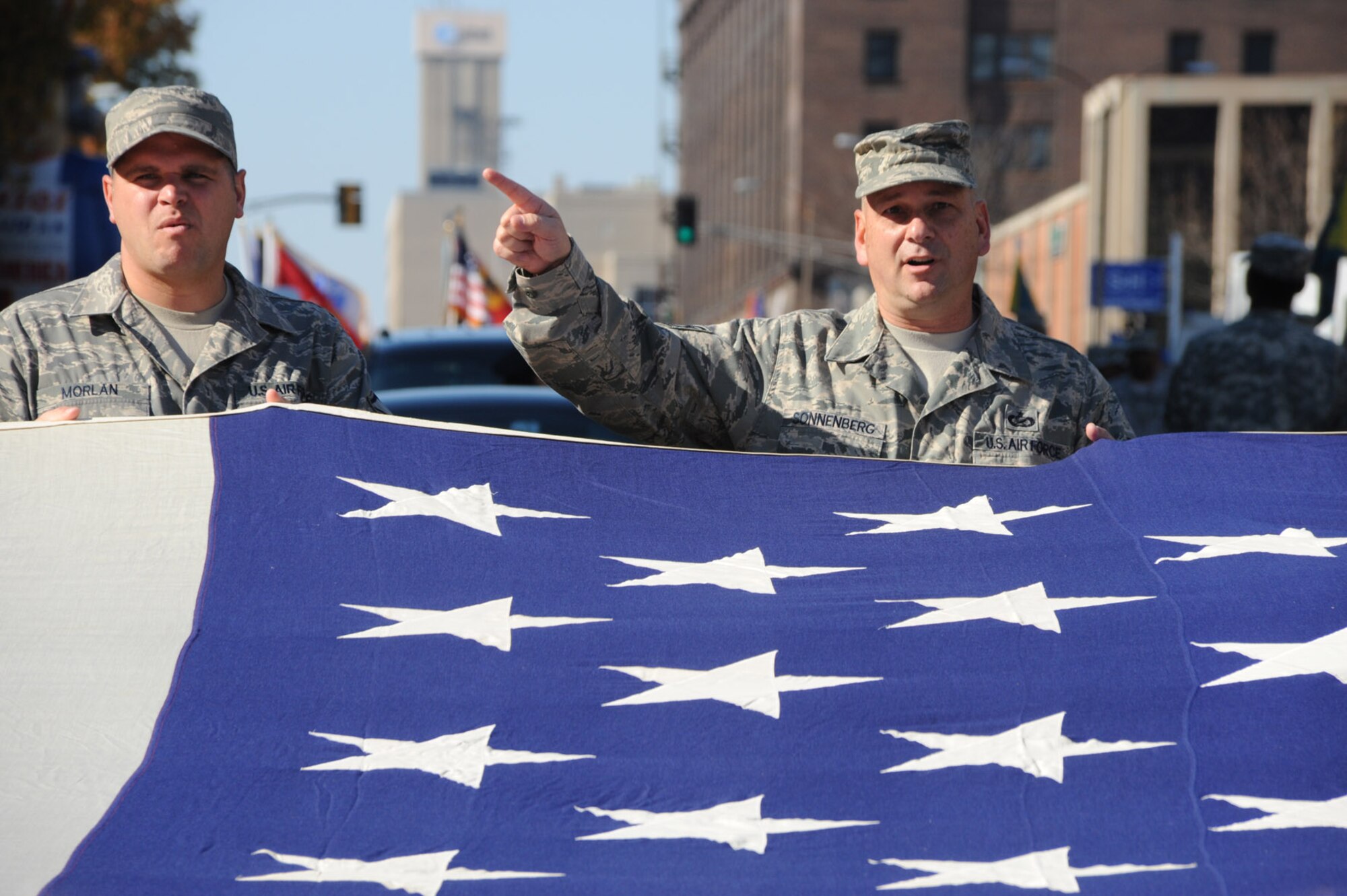 Tech. Sgt. Gerald Sonnenberg calls out directions for the wing to turn the American flag during a march recognizing veterans in Saint Louis.  He and 932nd Airlift Wing members spent time thanking other veterans on their special day.  (U.S. Air Force photo/Maj. Stan Paregien)