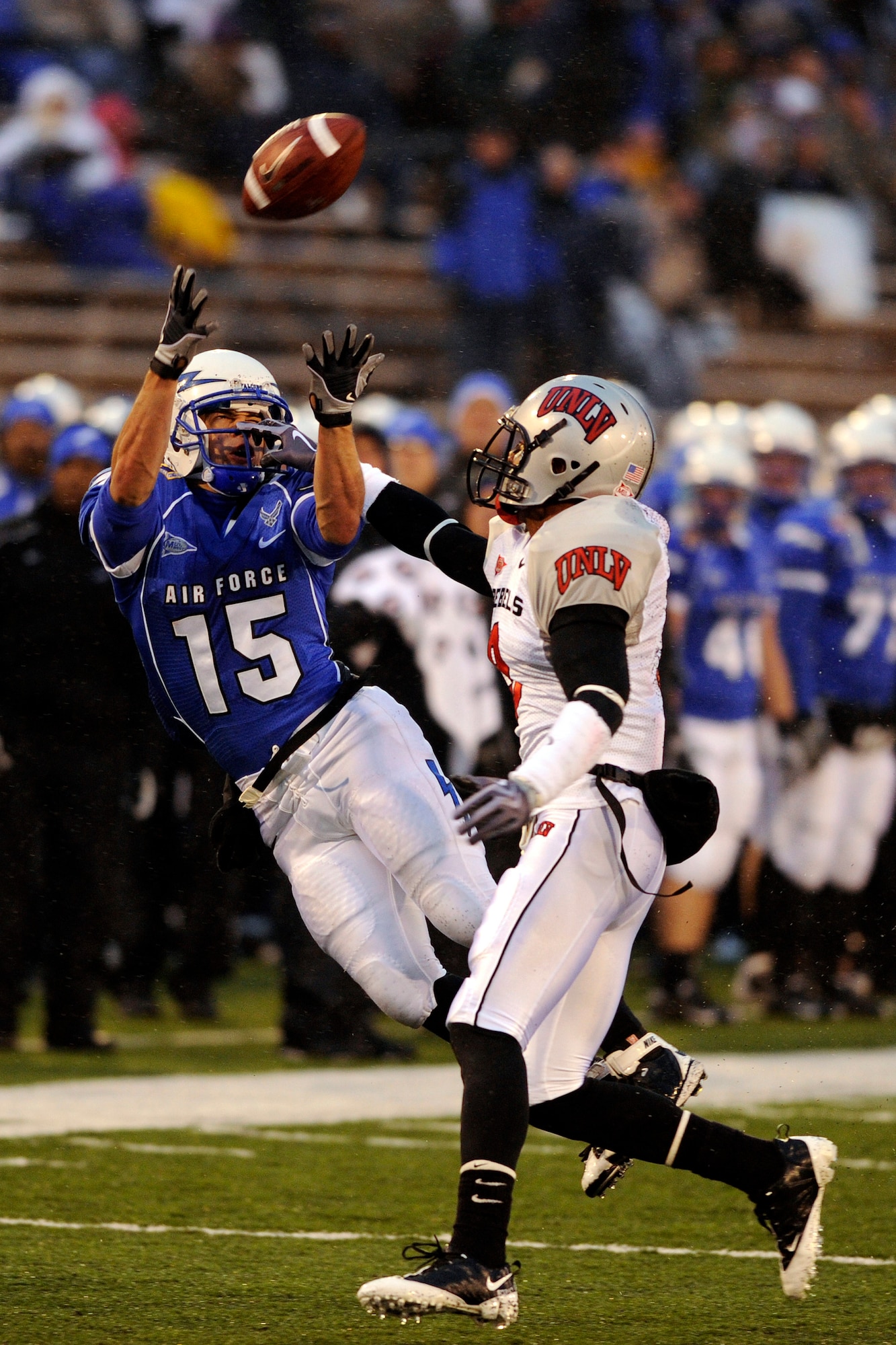 Falcons wide receiver Jonathan Warzeka goes up for a pass from quarterback Tim Jefferson in the Air Force-UNLV game at Falcon Stadium Nov. 14, 2009. The pass was incomplete, but the defender, Rebels defensive back Travis Dixon, was penalized for pass interference. Warzeka, a sophomore from Lake Elsinore, Calif., had four receptions for 43 yards in the Falcons' 45-17 victory. (U.S. Air Force photo/Bill Evans)