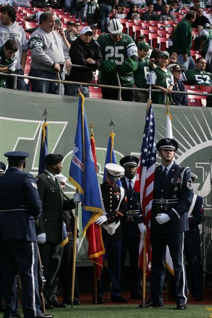 EAST RUTHERFORD, N.J. -- A joint-service color guard prepares for a pre-game ceremony at Giants Stadium, Nov. 15. Marine Corps, Air Force, Navy, Coast Guard and Army service members participated in a tribute to veterans before the game. A Coast Guard detachment sang the National Anthem and were joined by a joint-service color guard before the New York Jets game against the Jacksonville Jaguars. Chief Master Sgt. James A. Roy, Chief Master Sergeant of the Air Force, presented the coin for the pre-game coin toss.(Official Marine Corps photo by Sgt. Randall A. Clinton)