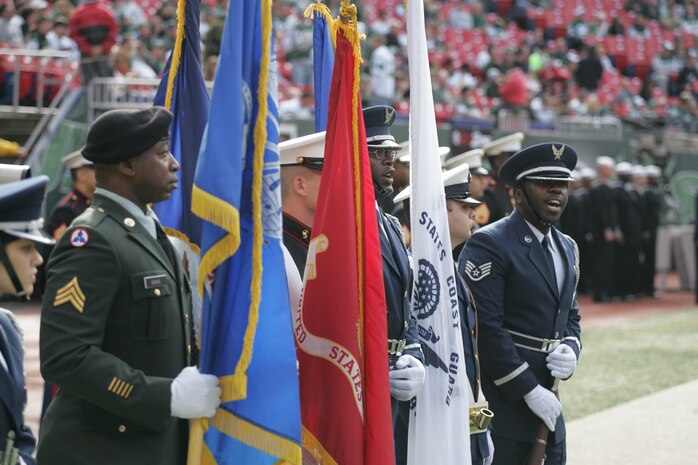 EAST RUTHERFORD, N.J. -- A joint-service color guard prepares for a pre-game ceremony at Giants Stadium, Nov. 15. Marine Corps, Air Force, Navy, Coast Guard and Army service members participated in a tribute to veterans before the game. A Coast Guard detachment sang the National Anthem and were joined by a joint-service color guard before the New York Jets game against the Jacksonville Jaguars. Chief Master Sgt. James A. Roy, Chief Master Sergeant of the Air Force, presented the coin for the pre-game coin toss.(Official Marine Corps photo by Sgt. Randall A. Clinton)