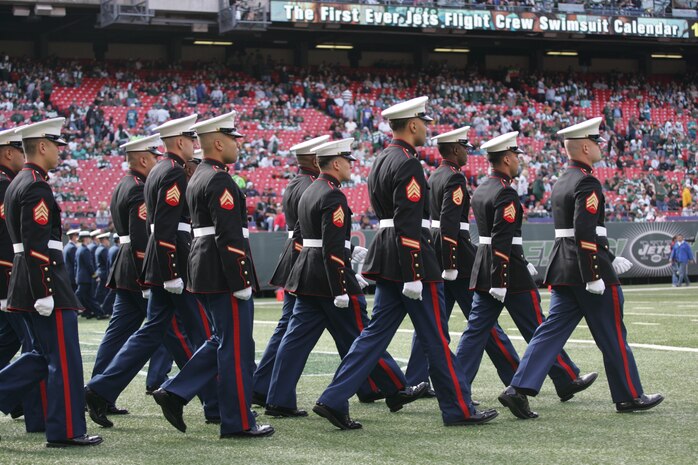 EAST RUTHERFORD, N.J. -- Marine Corps, Air Force, Navy, Coast Guard and Army service members march on to the field at Giants Stadium for a pre-game ceremony honoring veterans, Nov. 15. A Coast Guard detachment sang the National Anthem and were joined by a joint-service color guard before the New York Jets game against the Jacksonville Jaguars. Chief Master Sgt. James A. Roy, Chief Master Sergeant of the Air Force, presented the coin for the pre-game coin toss. (Official Marine Corps photo by Sgt. Randall A. Clinton)