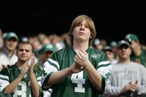 EAST RUTHERFORD, N.J. -- A New York Jets fan cheers on Marine Corps, Air Force, Navy, Coast Guard and Army service members as they march on field at Giants Stadium for a pre-game ceremony honoring veterans, Nov. 15. A Coast Guard detachment sang the National Anthem and were joined by a joint-service color guard before the New York Jets game against the Jacksonville Jaguars. Chief Master Sgt. James A. Roy, Chief Master Sergeant of the Air Force, presented the coin for the pre-game coin toss.(Official Marine Corps photo by Sgt. Randall A. Clinton)