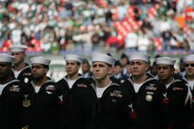 EAST RUTHERFORD, N.J. -- Marine Corps, Air Force, Navy, Coast Guard and Army service members stand at attention and salute during the singing of the National Anthem on the field at Giants Stadium for a pre-game ceremony honoring veterans, Nov. 15. A Coast Guard detachment sang the National Anthem and were joined by a joint-service color guard before the New York Jets game against the Jacksonville Jaguars. Chief Master Sgt. James A. Roy, Chief Master Sergeant of the Air Force, presented the coin for the pre-game coin toss.(Official Marine Corps photo by Sgt. Randall A. Clinton)