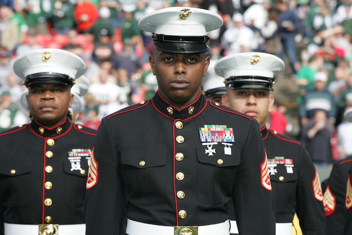 EAST RUTHERFORD, N.J. -- Marine Corps, Air Force, Navy, Coast Guard and Army service members stand at attention and salute during the singing of the National Anthem on the field at Giants Stadium for a pre-game ceremony honoring veterans, Nov. 15. A Coast Guard detachment sang the National Anthem and were joined by a joint-service color guard before the New York Jets game against the Jacksonville Jaguars. Chief Master Sgt. James A. Roy, Chief Master Sergeant of the Air Force, presented the coin for the pre-game coin toss.(Official Marine Corps photo by Sgt. Randall A. Clinton)