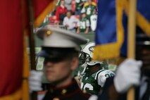EAST RUTHERFORD, N.J. -- Marine Corps, Air Force, Navy, Coast Guard and Army service members stand at attention and salute during the singing of the National Anthem on the field at Giants Stadium for a pre-game ceremony honoring veterans, Nov. 15. A Coast Guard detachment sang the National Anthem and were joined by a joint-service color guard before the New York Jets game against the Jacksonville Jaguars. Chief Master Sgt. James A. Roy, Chief Master Sergeant of the Air Force, presented the coin for the pre-game coin toss.(Official Marine Corps photo by Sgt. Randall A. Clinton)