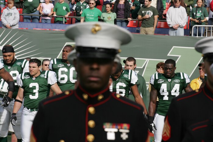 EAST RUTHERFORD, N.J. -- Marine Corps, Air Force, Navy, Coast Guard and Army service members stand at attention and salute during the singing of the National Anthem on the field at Giants Stadium for a pre-game ceremony honoring veterans, Nov. 15. A Coast Guard detachment sang the National Anthem and were joined by a joint-service color guard before the New York Jets game against the Jacksonville Jaguars. Chief Master Sgt. James A. Roy, Chief Master Sergeant of the Air Force, presented the coin for the pre-game coin toss.(Official Marine Corps photo by Sgt. Randall A. Clinton)