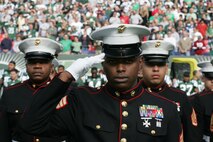 EAST RUTHERFORD, N.J. -- Marine Corps, Air Force, Navy, Coast Guard and Army service members stand at attention and salute during the singing of the National Anthem on the field at Giants Stadium for a pre-game ceremony honoring veterans, Nov. 15. A Coast Guard detachment sang the National Anthem and were joined by a joint-service color guard before the New York Jets game against the Jacksonville Jaguars. Chief Master Sgt. James A. Roy, Chief Master Sergeant of the Air Force, presented the coin for the pre-game coin toss.(Official Marine Corps photo by Sgt. Randall A. Clinton)