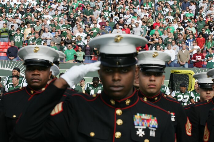 EAST RUTHERFORD, N.J. -- Marine Corps, Air Force, Navy, Coast Guard and Army service members stand at attention and salute during the singing of the National Anthem on the field at Giants Stadium for a pre-game ceremony honoring veterans, Nov. 15. A Coast Guard detachment sang the National Anthem and were joined by a joint-service color guard before the New York Jets game against the Jacksonville Jaguars. Chief Master Sgt. James A. Roy, Chief Master Sergeant of the Air Force, presented the coin for the pre-game coin toss.(Official Marine Corps photo by Sgt. Randall A. Clinton)