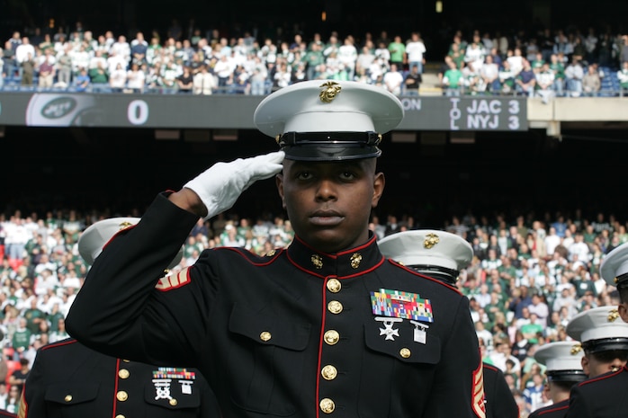 EAST RUTHERFORD, N.J. -- Marine Corps, Air Force, Navy, Coast Guard and Army service members stand at attention and salute during the singing of the National Anthem on the field at Giants Stadium for a pre-game ceremony honoring veterans, Nov. 15. A Coast Guard detachment sang the National Anthem and were joined by a joint-service color guard before the New York Jets game against the Jacksonville Jaguars. Chief Master Sgt. James A. Roy, Chief Master Sergeant of the Air Force, presented the coin for the pre-game coin toss.(Official Marine Corps photo by Sgt. Randall A. Clinton)