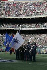 EAST RUTHERFORD, N.J. -- Marine Corps, Air Force, Navy, Coast Guard and Army service members stand at attention and salute during the singing of the National Anthem on the field at Giants Stadium for a pre-game ceremony honoring veterans, Nov. 15. A Coast Guard detachment sang the National Anthem and were joined by a joint-service color guard before the New York Jets game against the Jacksonville Jaguars. Chief Master Sgt. James A. Roy, Chief Master Sergeant of the Air Force, presented the coin for the pre-game coin toss.(Official Marine Corps photo by Sgt. Randall A. Clinton)