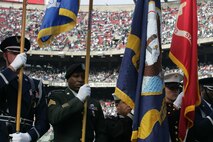 EAST RUTHERFORD, N.J. -- Marine Corps, Air Force, Navy, Coast Guard and Army service members march off to the field at Giants Stadium for a pre-game ceremony honoring veterans, Nov. 15. A Coast Guard detachment sang the National Anthem and were joined by a joint-service color guard before the New York Jets game against the Jacksonville Jaguars. Chief Master Sgt. James A. Roy, Chief Master Sergeant of the Air Force, presented the coin for the pre-game coin toss.(Official Marine Corps photo by Sgt. Randall A. Clinton)