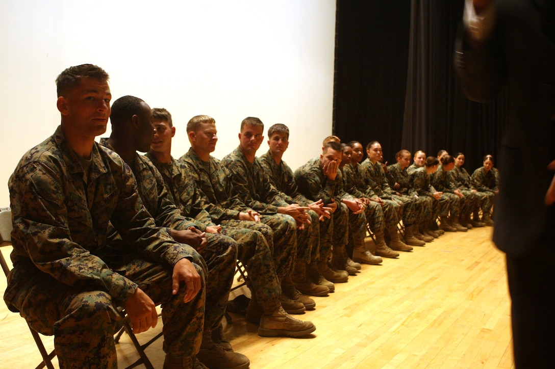 20 Marines that volunteered to be hypnotized wait for Bryan McDaniel to put them into a relaxed state at the base theater, Nov. 16. McDaniel performed a stage hypnosis show for a drunk driving safety brief.