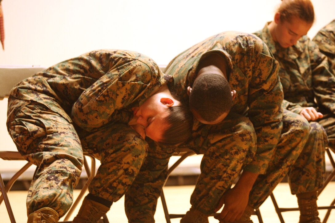 Two Marines lay asleep after being hypnotized by Bryan McDaniel at the base theater, Nov. 16. McDaniel performed the hypnosis show for a safety brief on drinking and driving.