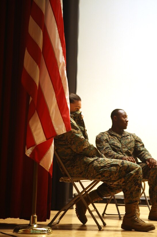 A corporal covers her nose with her blouse after being told the person next to her was giving off the worst odor she had ever smelled. The Marines were volunteers to be hypnotized during a safety presentation by Bryan McDaniel, a professional hypnotist, at the base theater, Nov. 16.