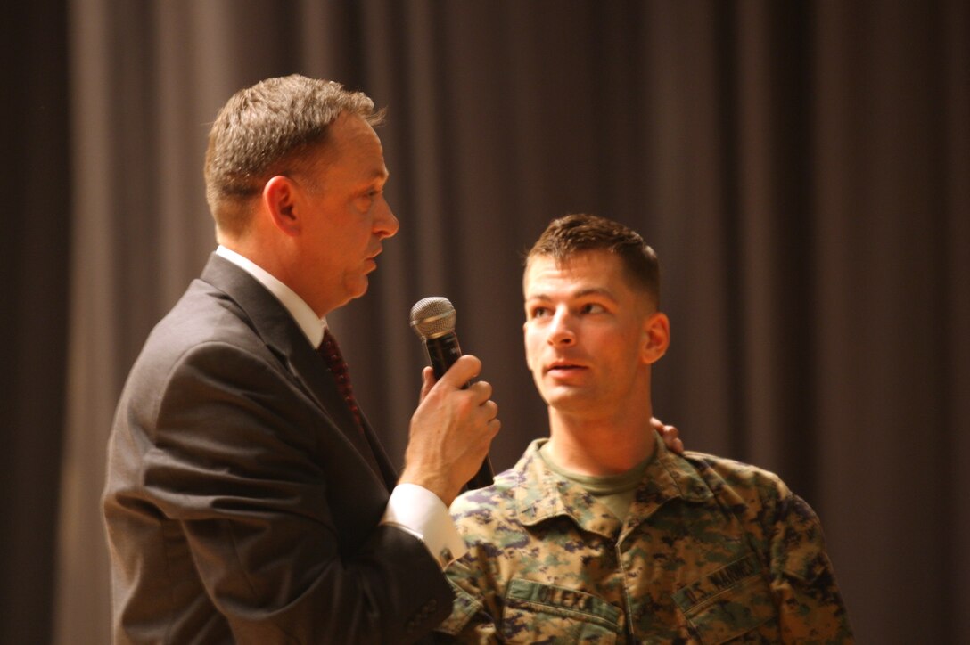 Bryan McDaniel, a professional hypnotist questions Pfc. Russel Olexa Jr., a rifleman with 1st Battalion, 2nd Marine Regiment, 2nd Marine Division, about how he feels after being told he was the driver in a car crash that killed three of his friends. The skit was part of a safety hypnosis show at the base theater, Nov. 16.