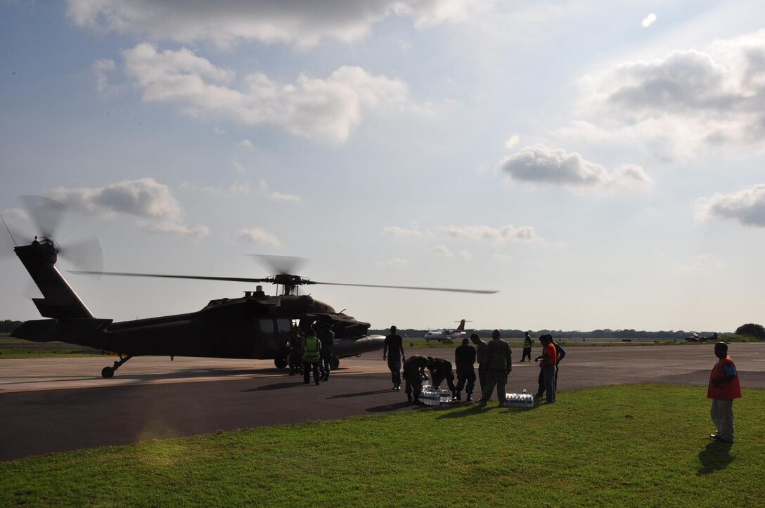 ILOPANGO, El Salvador – Salvadoran military, USAID workers and U.S. servicemembers load a UH-60 Blackhawk, assigned to Joint Task Force-Bravo, with water and hygiene Nov. 16. The four Joint Task Force-Bravo helicopters transported 97,000 pounds of relief supplies today reaching 315,200 total pounds delivered since Nov. 11(U.S. Air Force photo/Staff Sgt. Chad Thompson).