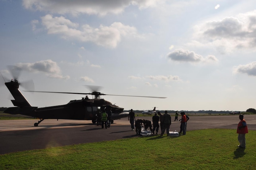 ILOPANGO, El Salvador – Salvadoran military, USAID workers and U.S. servicemembers load a UH-60 Blackhawk, assigned to Joint Task Force-Bravo, with water and hygiene Nov. 16. The four Joint Task Force-Bravo helicopters transported 97,000 pounds of relief supplies today reaching 315,200 total pounds delivered since Nov. 11(U.S. Air Force photo/Staff Sgt. Chad Thompson).