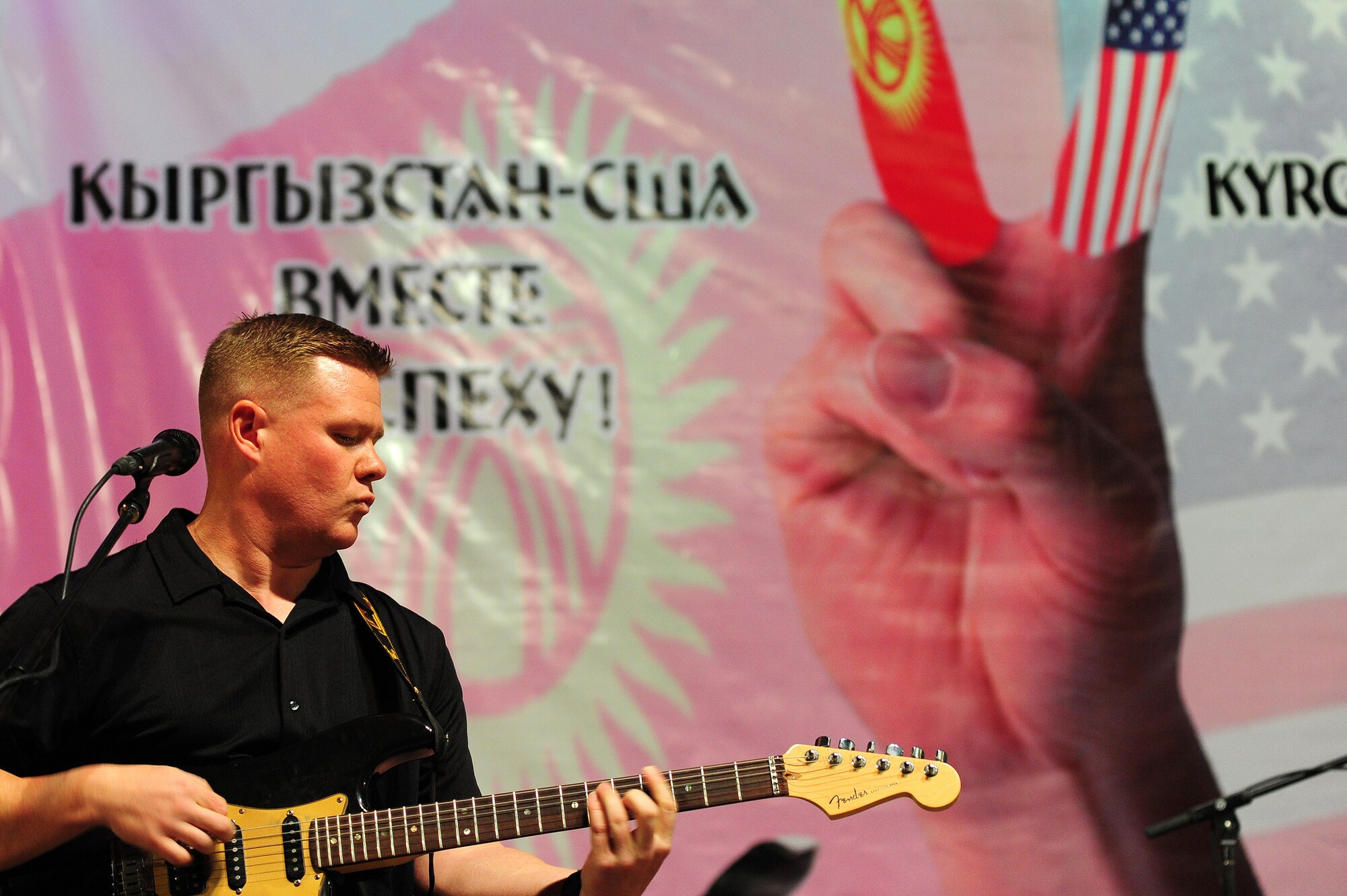 BISHKEK, Kyrgyzstan -- Tech. Sgt. Steve Wilson, U.S. Air Forces Central Sirocco Band guitarist, plays a solo during a performance at the Seitek Youth Center in Kyrgzstan, Nov. 14, 2009. The Sirocco Band is traveling throughout deployed locations in Asia to improve the morale of troops and build new relationships with native audiences, both large and small. The Sirocco Band members are deployed from Lackland Air Force Base, Texas.(U.S. Air Force photo/Senior Airman Steele C. G. Britton)
