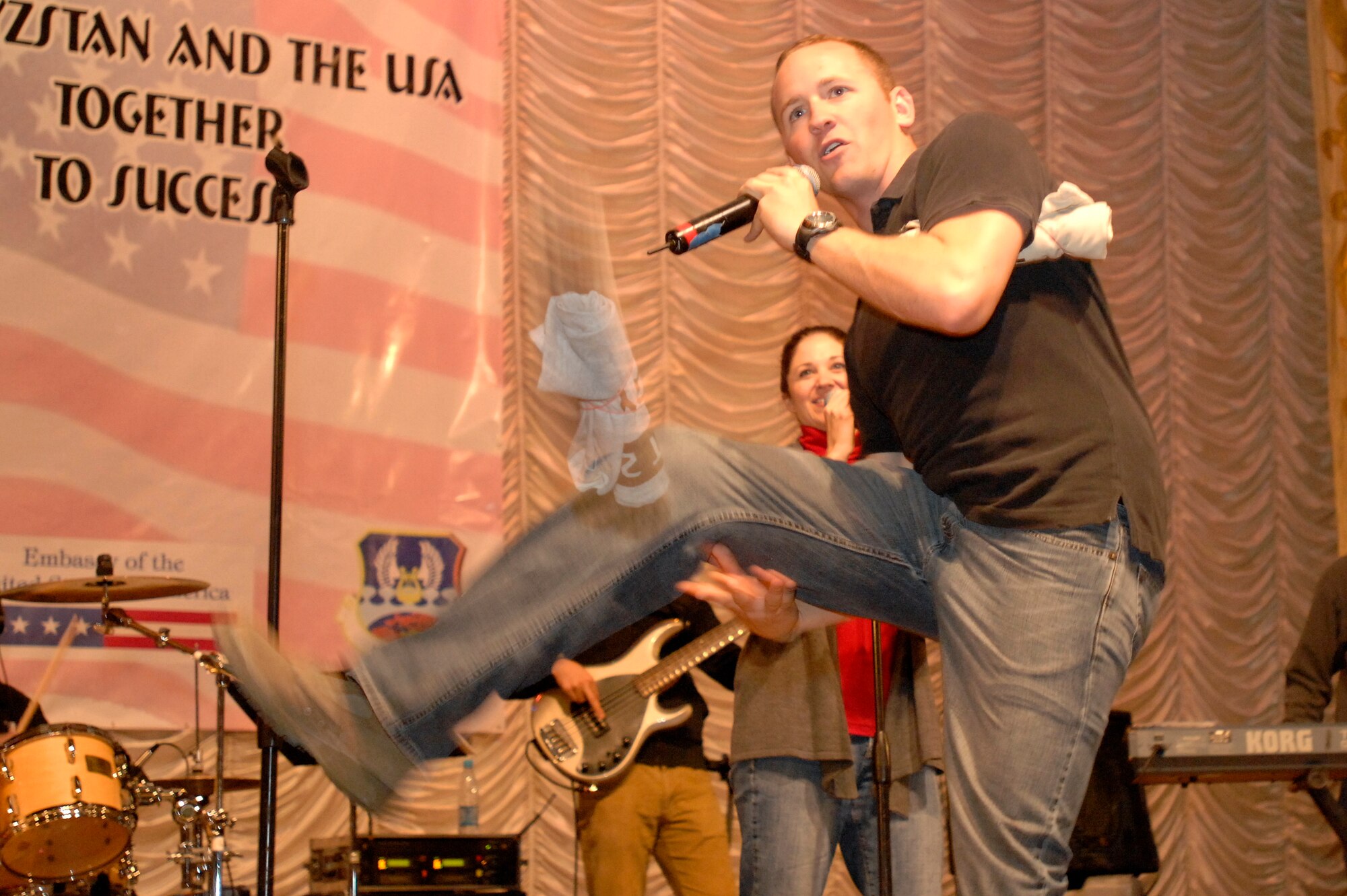 BISHKEK, Kyrgyzstan -- Airman 1st Class Clayton Lee, U.S. Air Forces Central Sirocco Band vocalist tosses Transit Center at Manas t-shirts to the crowd during a performance at the Seitek Youth Center, Nov. 14, 2009. (U.S. Air Force photo/Senior Master Sgt. Andrew E. Lynch)