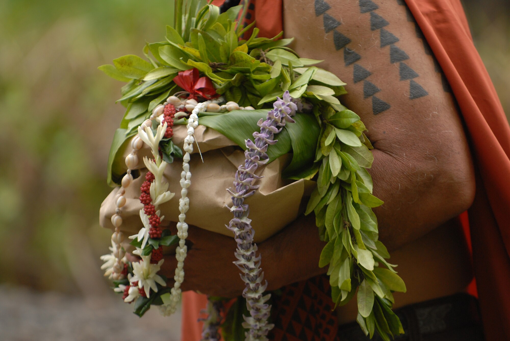 HICKAM AIR FORCE BASE, Hawaii -- Gifts are offered at the Haleamau Halealoha Burial after the Makahiki Festival here, Nov. 14. The gifts were set on the burial to respect and honor the ancestors of Hawaiians who came before them. (U.S. Air Force photo/Senior Airman Gustavo Gonzalez)