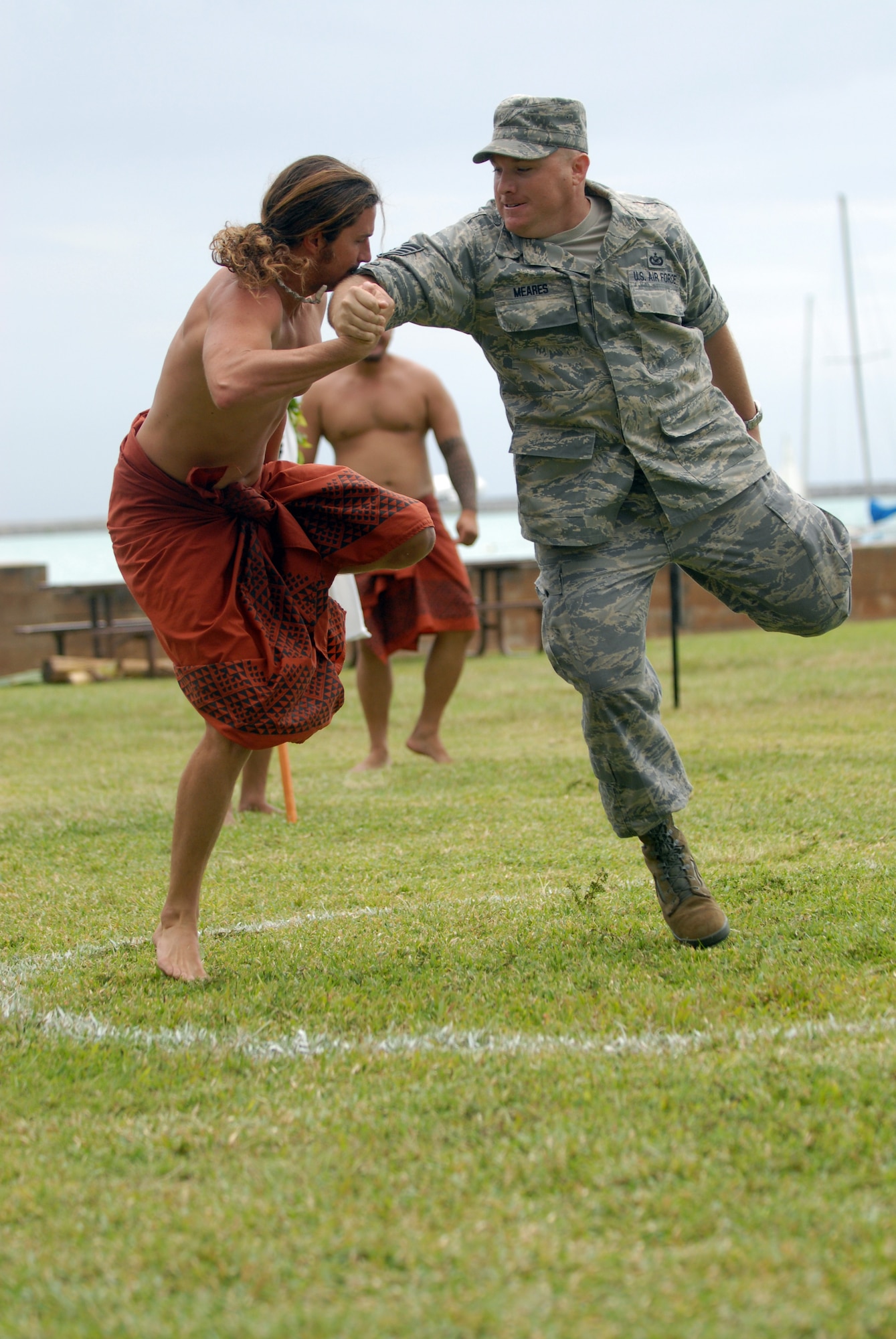HICKAM AIR FORCE BASE, Hawaii -- Staff Sgt. Mike Meares, 15th Airlift Wing public affairs, competes in the Hakamoa (one legged wrestling) event against a local competitor during the Makahiki Festival here, Nov. 14. For more than two-thousand years, the significance of Lono and his contributions to the beliefs and practices of the early Hawaiian people, influenced the celebration of events held during the Makahiki Festival throughout the Hawaiian Islands. Since Lono was the embodiment of all the characteristics of peace and welfare, all warfare was strictly forbidden during the time of the Makahiki. Since Lono represented the spiritual life-force that came out of all agricultural efforts, much feasting of every kind was done during the four months of the Makahiki. This focus on health and welfare made games of skill that tested a healthy body and mind a focal point of the Makahiki games. (U.S. Air Force photo/Senior Airman Gustavo Gonzalez)