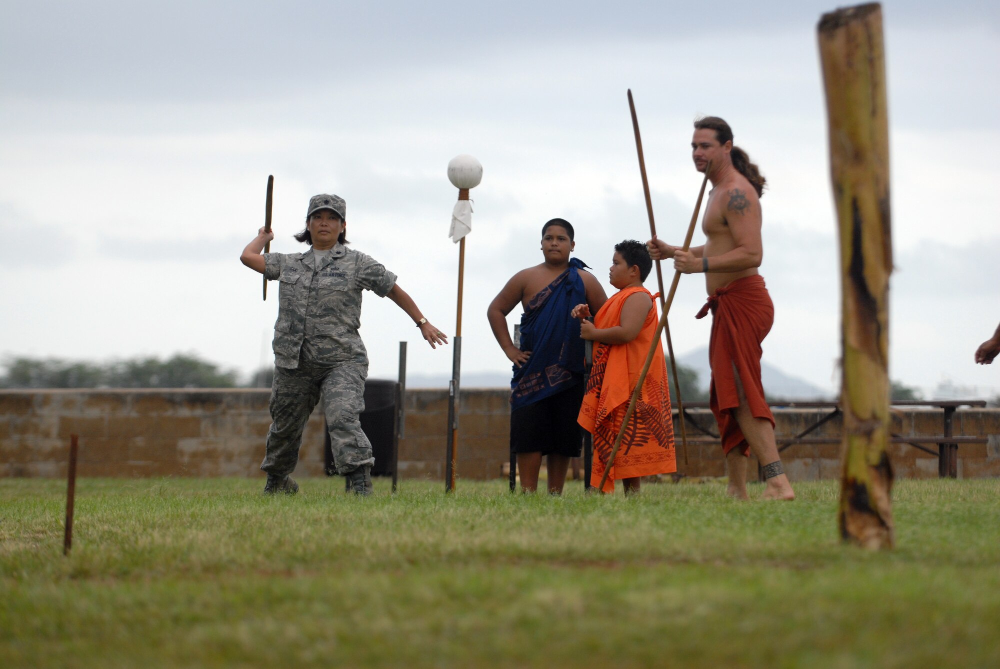 HICKAM AIR FORCE BASE, Hawaii -- Lt. Col. Tracey Saiki, 15th Airlift Wing public affairs, attempts to throw a spear into a trunk during the O'o Ihe event at the Makahiki Festival here, Nov. 14. For more than two-thousand years, the significance of Lono and his contributions to the beliefs and practices of the early Hawaiian people, influenced the celebration of events held during the Makahiki Festival throughout the Hawaiian Islands. Since Lono was the embodiment of all the characteristics of peace and welfare, all warfare was strictly forbidden during the time of the Makahiki. Since Lono represented the spiritual life-force that came out of all agricultural efforts, much feasting of every kind was done during the four months of the Makahiki. This focus on health and welfare made games of skill that tested a healthy body and mind a focal point of the Makahiki games. (U.S. Air Force photo/Senior Airman Gustavo Gonzalez)